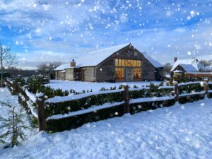 Winter wedding venue in Surrey – High Billinghurst Farm barn with snow and fairy lights