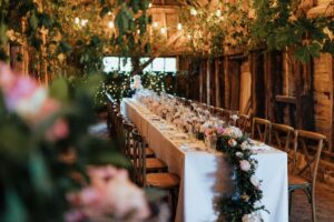Long banquet table decorated with flowers and candles for a micro wedding at High Billinghurst Farm