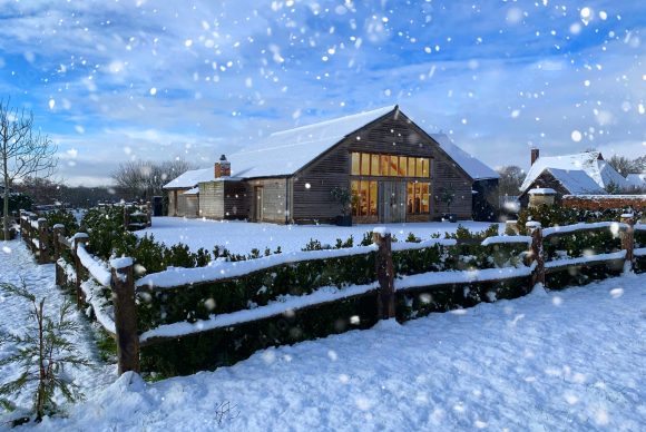 Winter wedding venue in Surrey – High Billinghurst Farm barn with snow and fairy lights